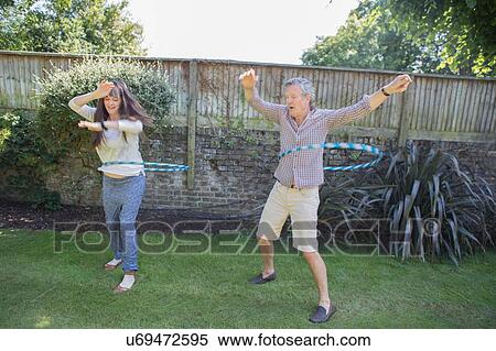 "Senior couple, playing with plastic hoops in garden" View Large Photo Image Stock Photography - "Senior couple, playing with plastic hoops in garden". Fotosearch