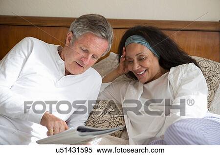 Senior couple relaxing on bed View Large Photo Image Stock Photography - Senior couple relaxing on bed. Fotosearch