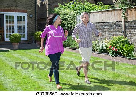 "Senior couple running in garden, laughing" View Large Photo Image Stock Image - "Senior couple running in garden, laughing". Fotosearch