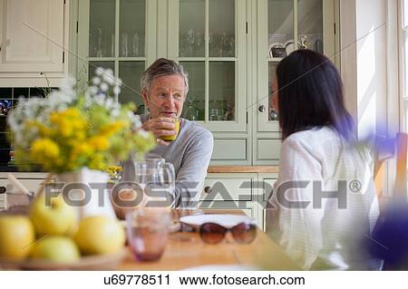 "Senior couple, sitting at table together" View Large Photo Image Stock Image - "Senior couple, sitting at table together". Fotosearch