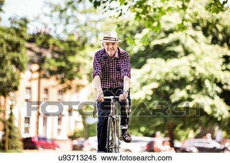 "Senior man cycling, Hackney Park, London" View Large Photo Image Stock Photography - "Senior man cycling, Hackney Park, London". Fotosearch