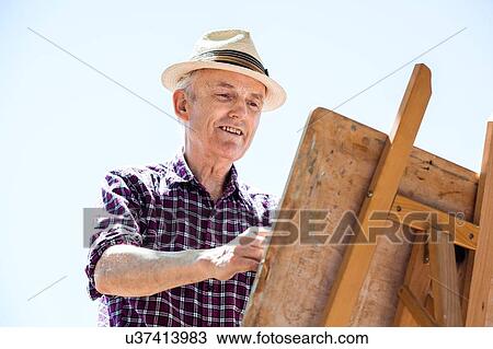 "Senior man drawing in park, Hackney, London" View Large Photo Image Stock Image - "Senior man drawing in park, Hackney, London". Fotosearch