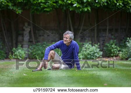 Picture - Senior man sitting in garden. Fotosearch