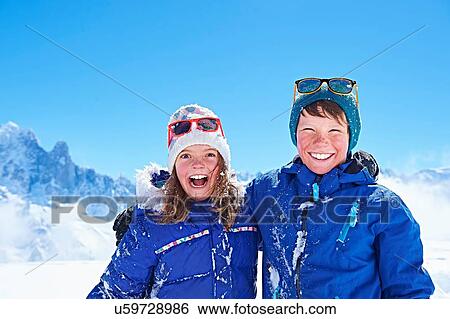 Stock Photograph - "Siblings in winter clothing, Chamonix, France". Fotosearch