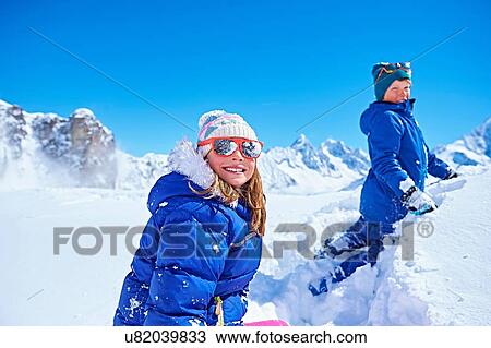 Stock Image - "Siblings playing in snow, Chamonix, France". Fotosearch