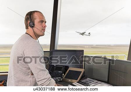 "Side view of young man in air traffic control tower, looking away, airplane taking off behind" View Large Photo Image Stock Photo - "Side view of young man in air traffic control tower, looking away, airplane taking off behind". Fotosearch