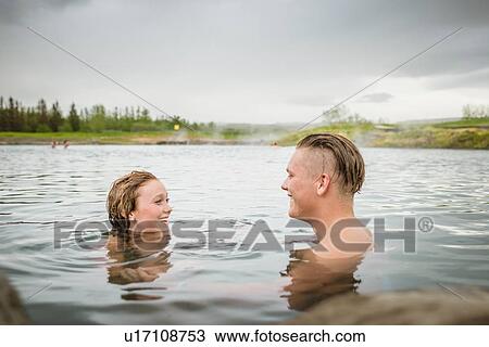 "Smiling young couple relaxing in Secret Lagoon hot spring (Gamla Laugin), Fludir, Iceland" View Large Photo Image Stock Image - "Smiling young couple relaxing in Secret Lagoon hot spring (Gamla Laugin), Fludir, Iceland". Fotosearch