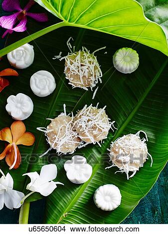 Picture - Still life of asian dessert confectionary on banana leaf. Fotosearch
