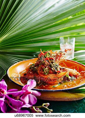 Stock Photography - Still life of Pla Goong on plate with spicy vegetable garnish. Fotosearch