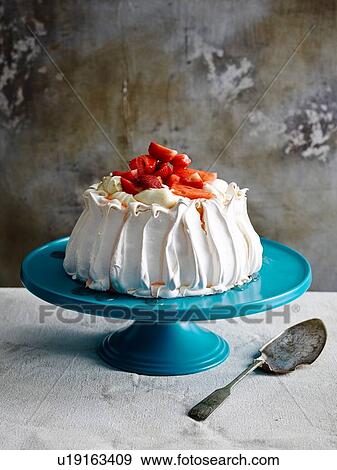 Strawberry covered pavlova on blue ceramic cake stand with cake server View Large Photo Image Stock Photo - Strawberry covered pavlova on blue ceramic cake stand with cake server. Fotosearch
