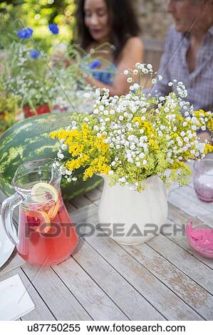 "Table laid for lunch, outdoors, senior couple in background" View Large Photo Image Stock Photography - "Table laid for lunch, outdoors, senior couple in background". Fotosearch