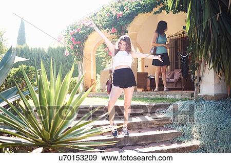 Teenage girl posing on holiday apartment steps with arms open View Large Photo Image Stock Photo - Teenage girl posing on holiday apartment steps with arms open. Fotosearch