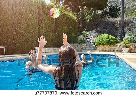 Teenage girl throwing ball to mother and brother in swimming pool View Large Photo Image Stock Image - Teenage girl throwing ball to mother and brother in swimming pool. Fotosearch