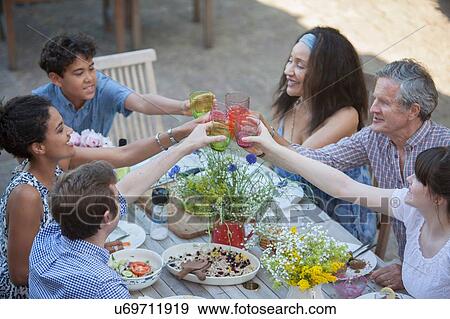 Three generation family eating meal outdoors View Large Photo Image Stock Photo - Three generation family eating meal outdoors. Fotosearch