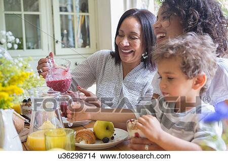 Three generation family eating breakfast together View Large Photo Image Picture - Three generation family eating breakfast together. Fotosearch