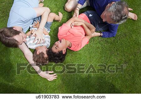 Three generation family fooling around in garden View Large Photo Image Stock Image - Three generation family fooling around in garden. Fotosearch