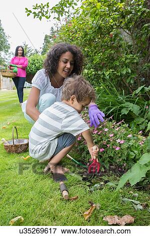 "Three generation family, gardening together" View Large Photo Image Stock Photo - "Three generation family, gardening together". Fotosearch