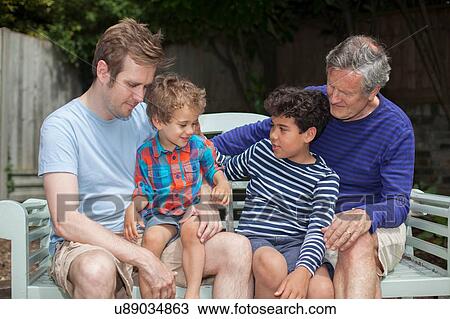 Three generation family in garden View Large Photo Image Stock Image - Three generation family in garden. Fotosearch
