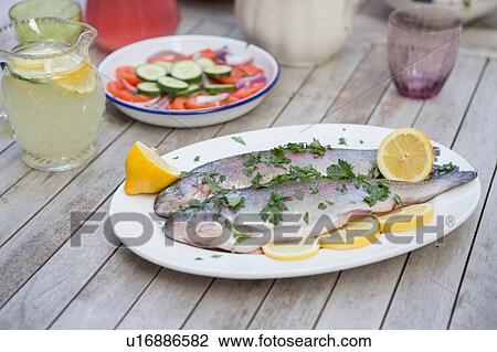Stock Image - "Trout on plate, ready to barbecue". Fotosearch