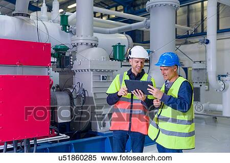 Two engineers using digital tablet at geothermal power station View Large Photo Image Stock Photography - Two engineers using digital tablet at geothermal power station. Fotosearch