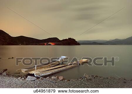 "Two fishing boats moored on lakeside, Lugu Lake, Yunnan, China" View Large Photo Image Stock Photo - "Two fishing boats moored on lakeside, Lugu Lake, Yunnan, China". Fotosearch