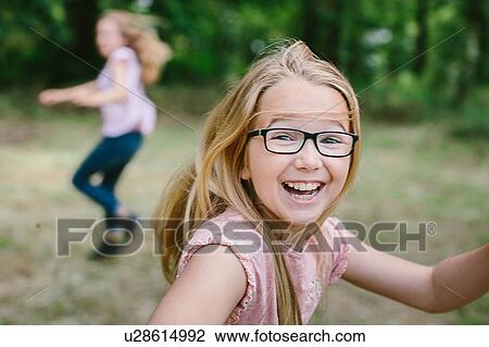 "Two young girls, running, outdoors" View Large Photo Image Stock Image - "Two young girls, running, outdoors". Fotosearch