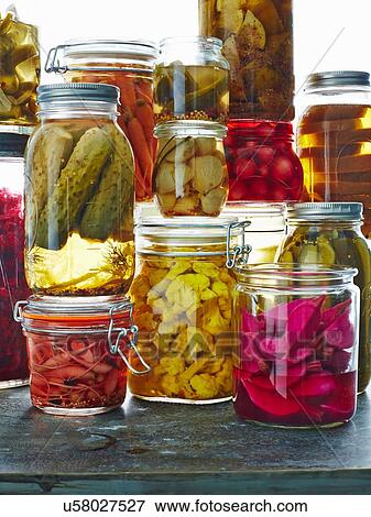 Stock Photo - "Various pickles in glass jars, close-up". Fotosearch