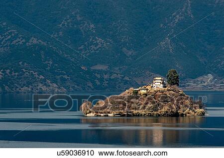 "View of house on top of small island on Lugu Lake at dusk, Yunnan, China" View Large Photo Image Stock Image - "View of house on top of small island on Lugu Lake at dusk, Yunnan, China". Fotosearch