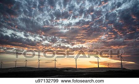 Wind turbines in a row on wind farm against dramatic sky View Large Photo Image Stock Photo - Wind turbines in a row on wind farm against dramatic sky. Fotosearch