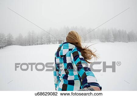 Stock Image - "Woman enjoying snow, Sattelbergalm, Tirol, Austria". Fotosearch
