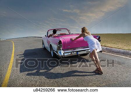 Woman pushing Convertible on road View Large Photo Image Stock Photograph - Woman pushing Convertible on road. Fotosearch