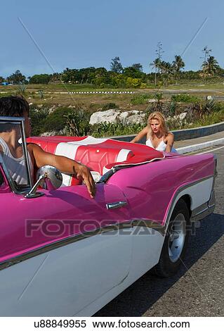 Stock Photography - Woman pushing Convertible on road. Fotosearch