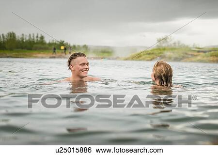 "Young couple relaxing in Secret Lagoon hot spring (Gamla Laugin), Fludir, Iceland" View Large Photo Image Stock Photograph - "Young couple relaxing in Secret Lagoon hot spring (Gamla Laugin), Fludir, Iceland". Fotosearch