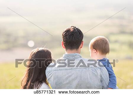 "Young family looking at rural view, rear view" View Large Photo Image Stock Image - "Young family looking at rural view, rear view". Fotosearch