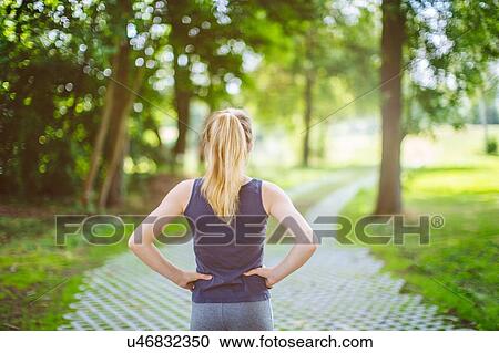Stock Image - "Young girl, outdoors, hands on hips, preparing herself for run". Fotosearch
