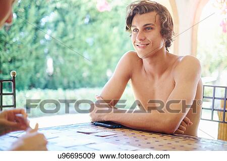 Young man and mother playing cards at patio table View Large Photo Image Stock Photo - Young man and mother playing cards at patio table. Fotosearch