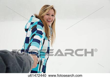 Stock Image - "Young woman enjoying snow, Sattelbergalm, Tirol, Austria". Fotosearch