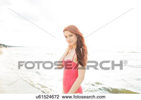 Stock Image - Young woman in bikini on beach. Fotosearch