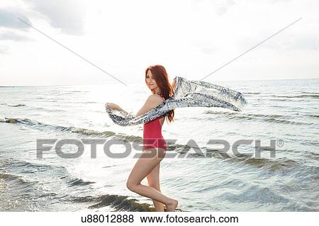 Stock Photo - Young woman in bikini on beach. Fotosearch