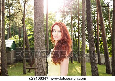 Stock Photo - Young woman in park. Fotosearch