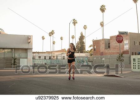 Young woman jogging in street View Large Photo Image Stock Photography - Young woman jogging in street. Fotosearch