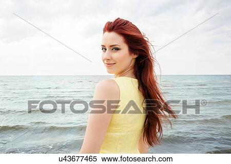 Stock Photography - Young woman on beach. Fotosearch