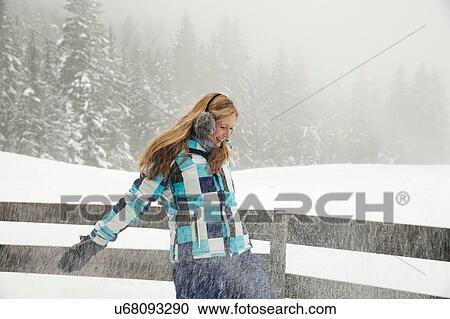 "Young woman playing in snow, Sattelbergalm, Tirol, Austria" View Large Photo Image Stock Image - "Young woman playing in snow, Sattelbergalm, Tirol, Austria". Fotosearch