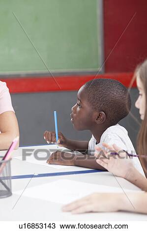 Stock Image - African boy drawing. Fotosearch