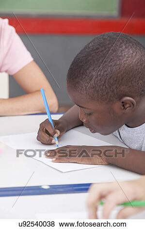 Stock Photo - African boy drawing. Fotosearch