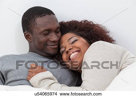 Picture - African couple sleeping. Fotosearch