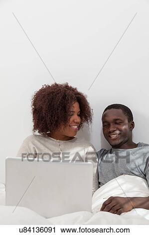 Stock Image - African couple using the computer. Fotosearch