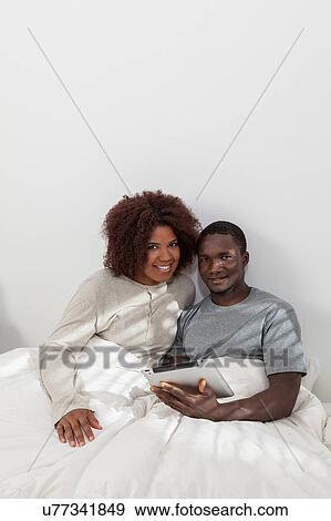 African couple using the computer View Large Photo Image Stock Photo - African couple using the computer. Fotosearch