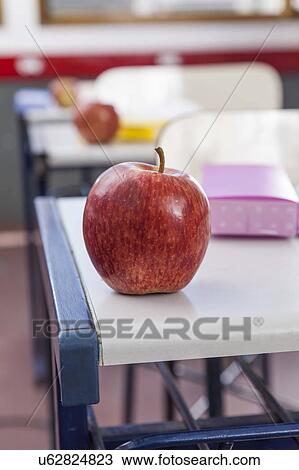 Stock Image - An apple on the desk. Fotosearch
