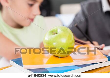 apple on books View Large Photo Image Picture - apple on books . Fotosearch